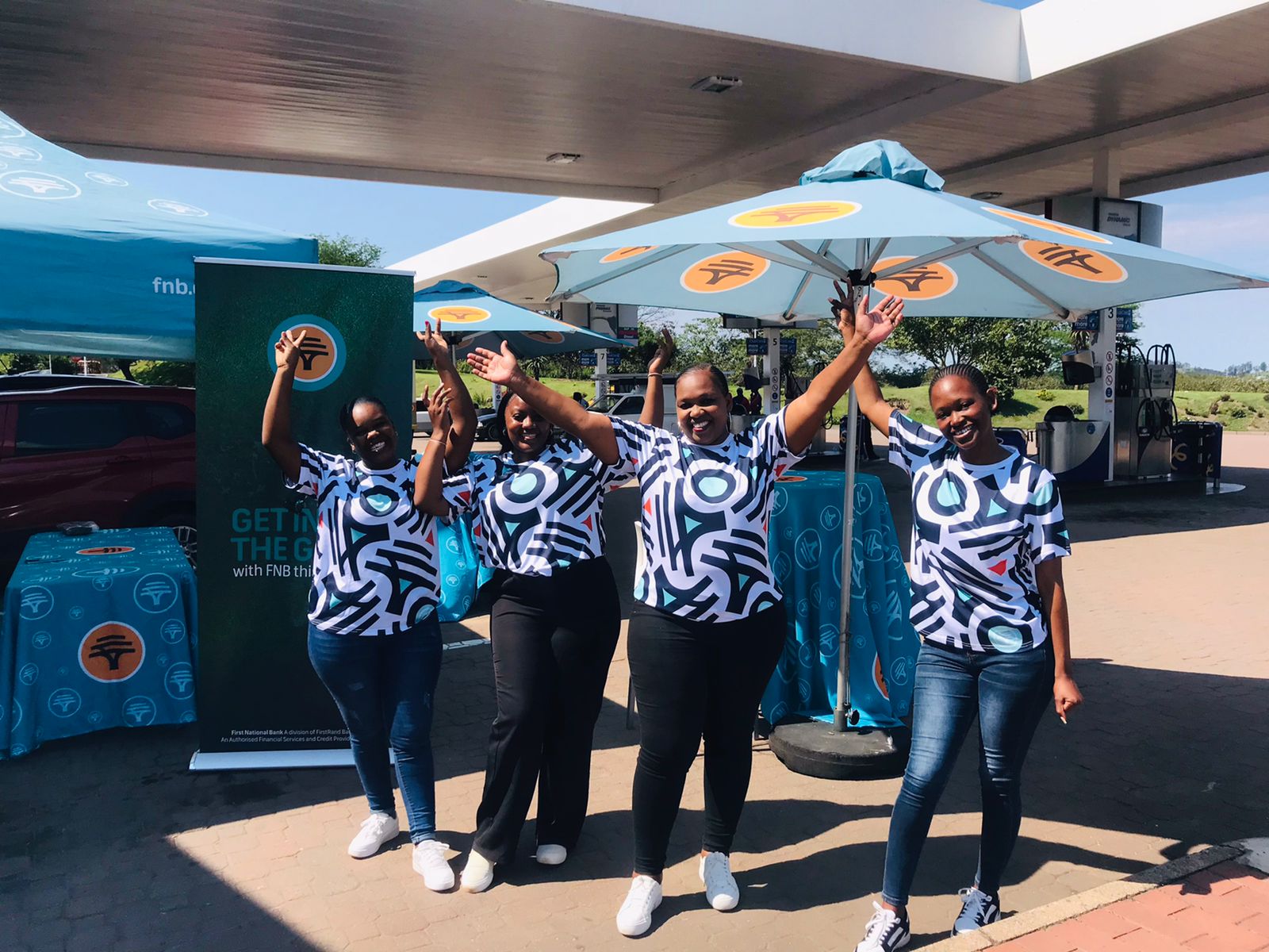 FNB brand ambassadors celebrating at a service station activation